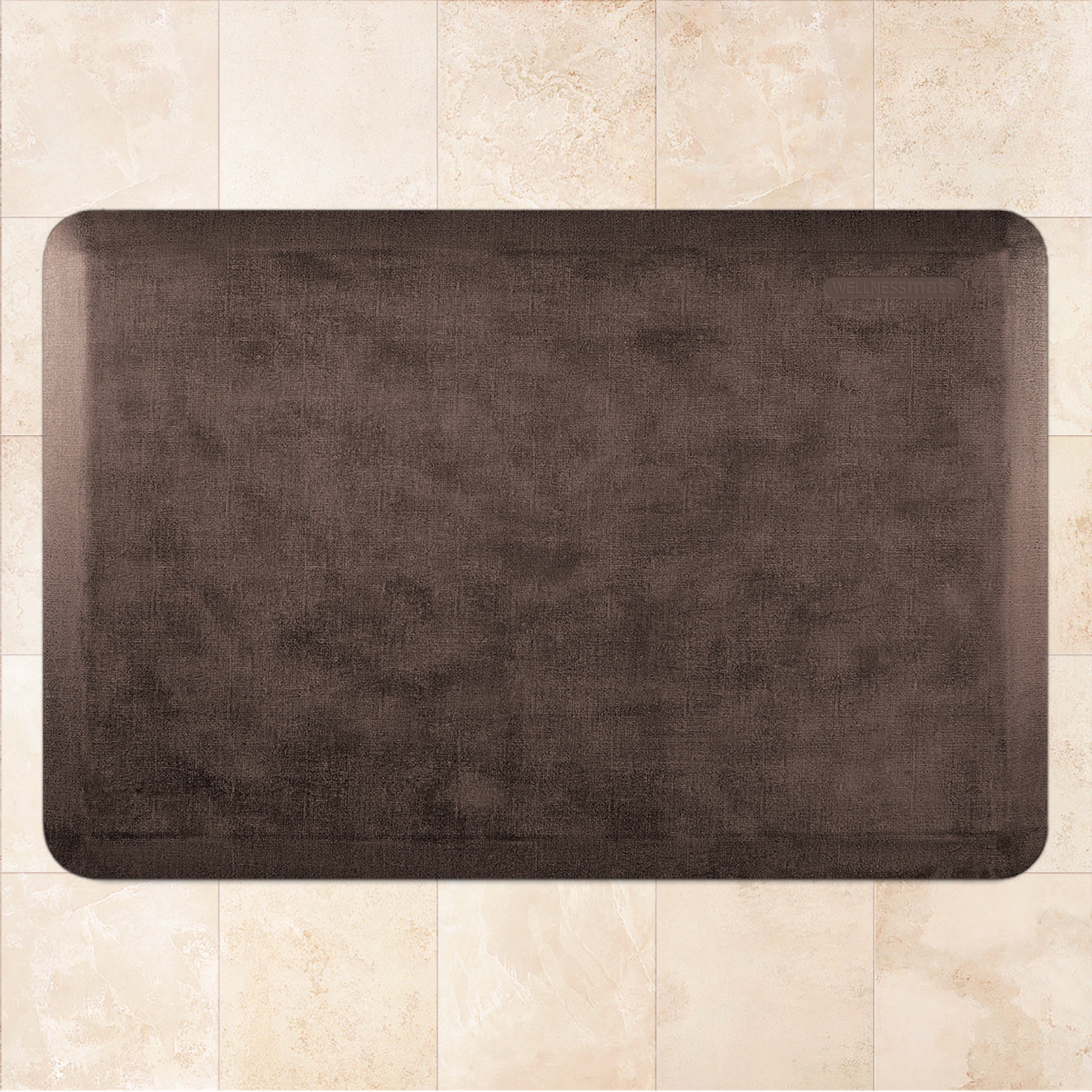A 3'x2' Antique Dark WellnessMat on a tile floor.