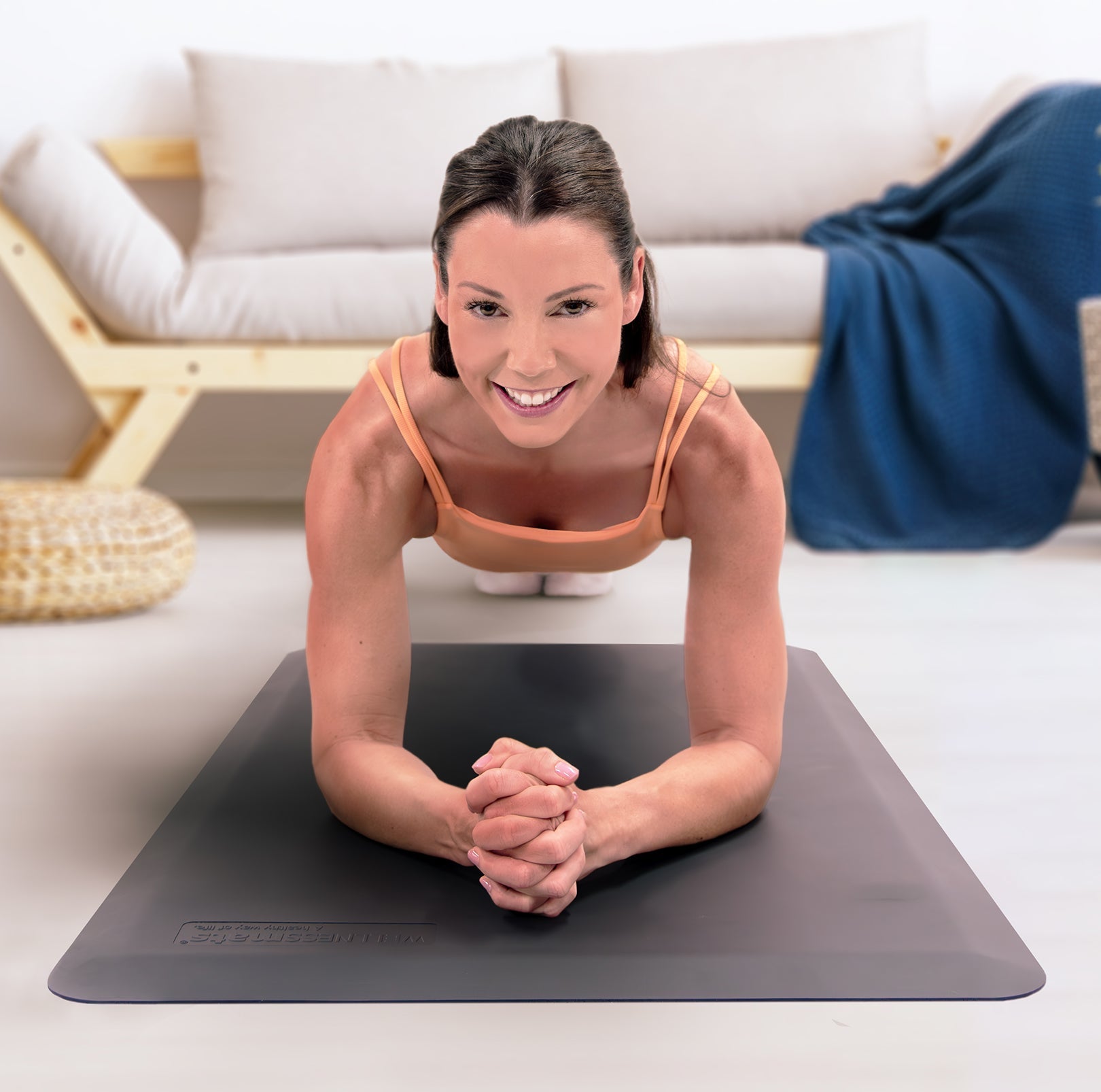 Woman on gray FitnessMat in living room